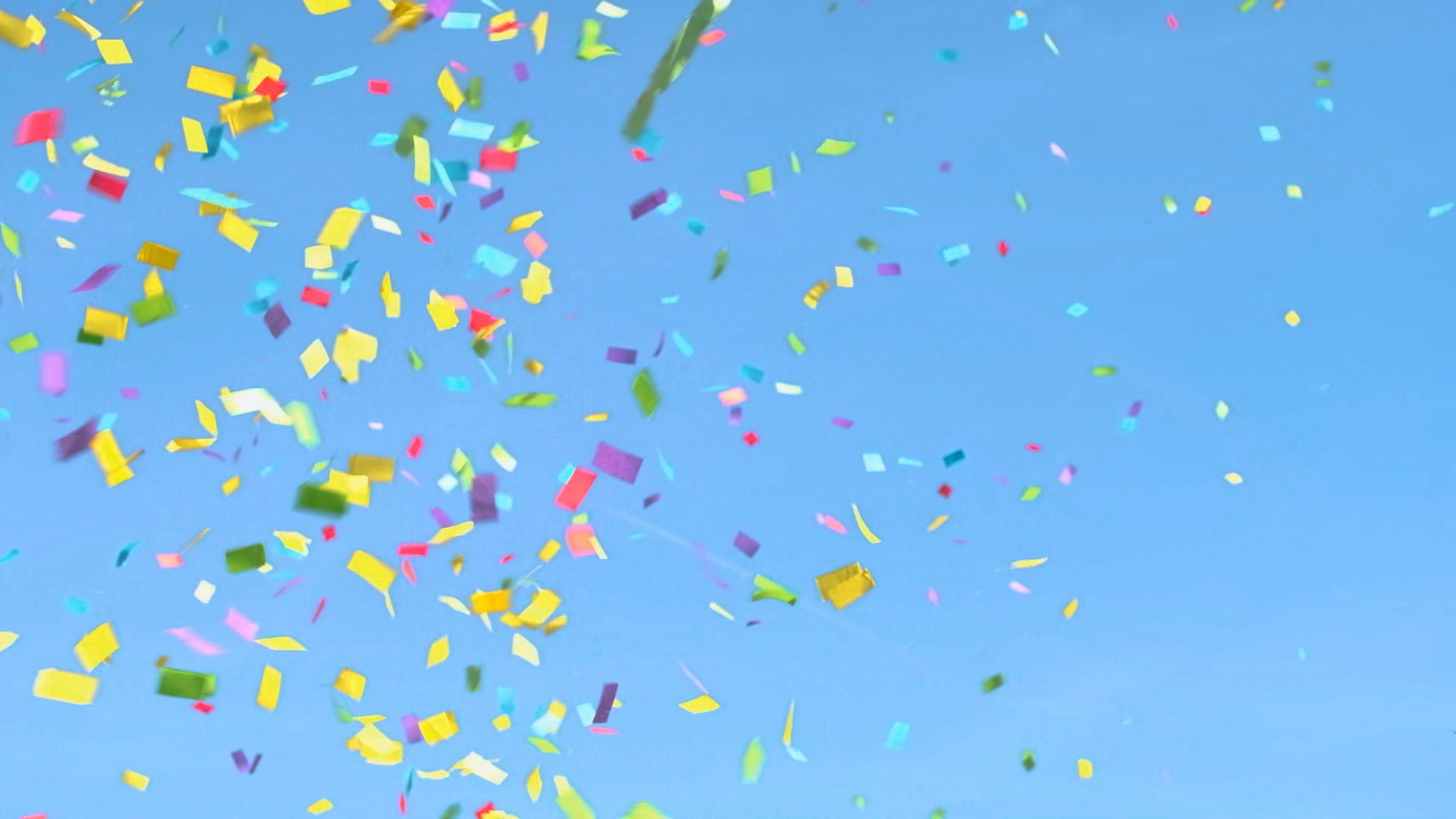 How to live joyfully: An image of a bright blue sky with multicolored confetti falling in front of it.